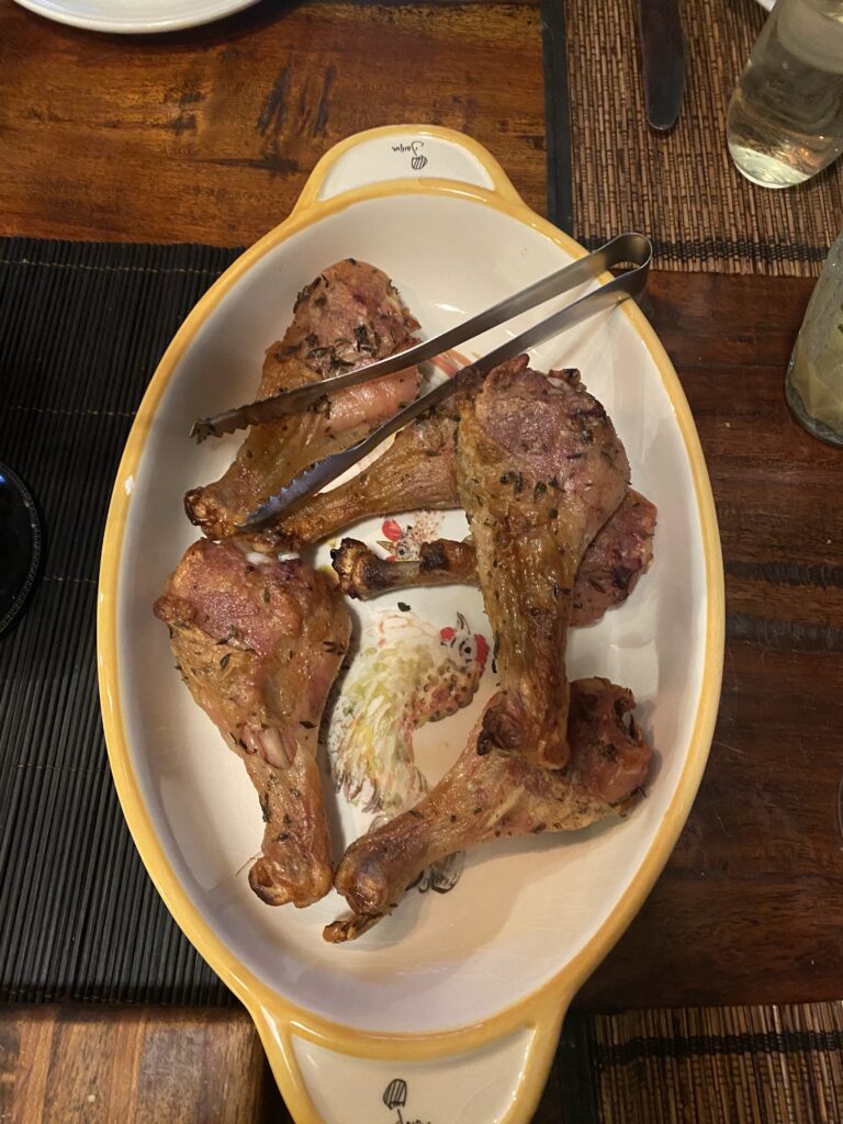 Several crispy chicken legs nestled in a chicken-themed serving dish.